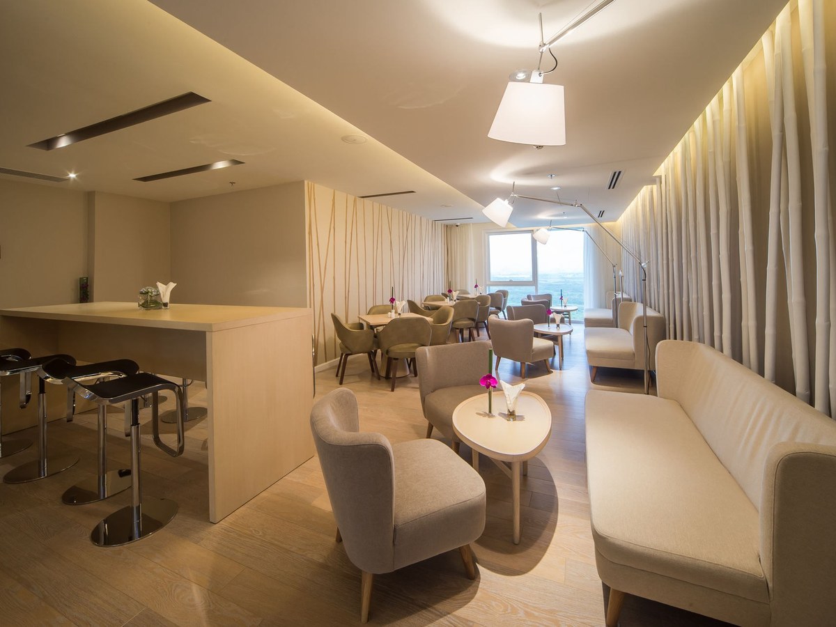Lounge bar with stools, armchairs and pendant lights