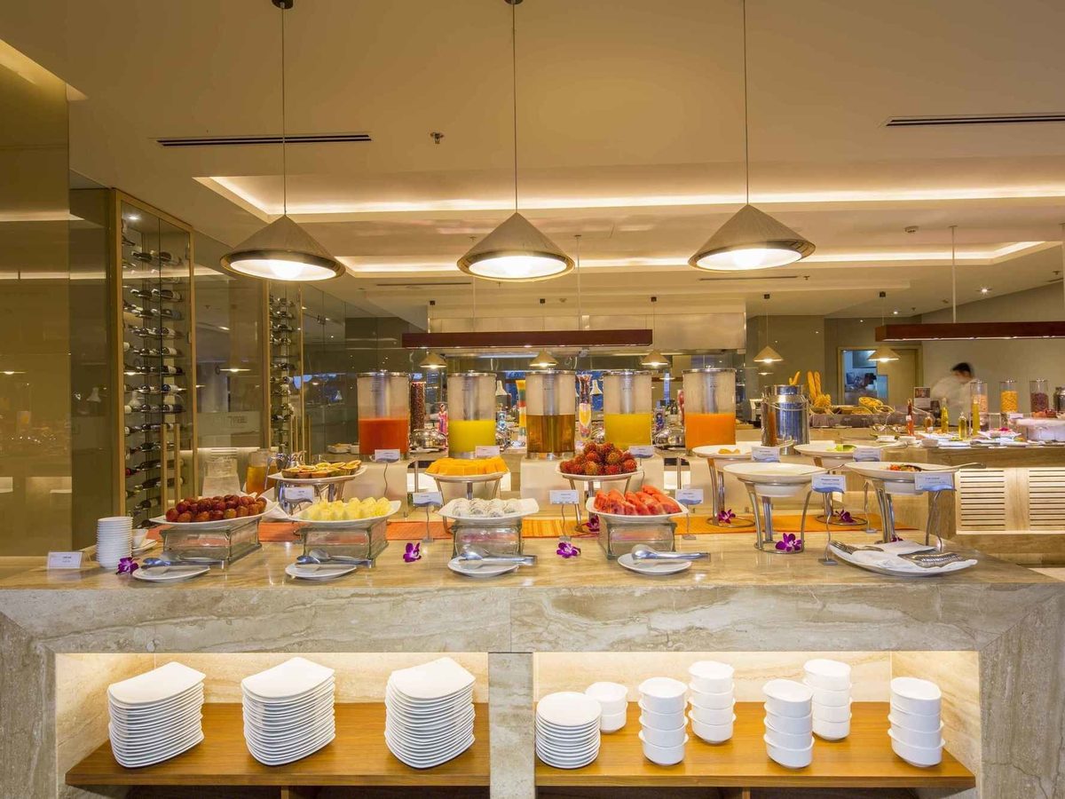 Breakfast buffet counter with cereals, juices and hot dishes